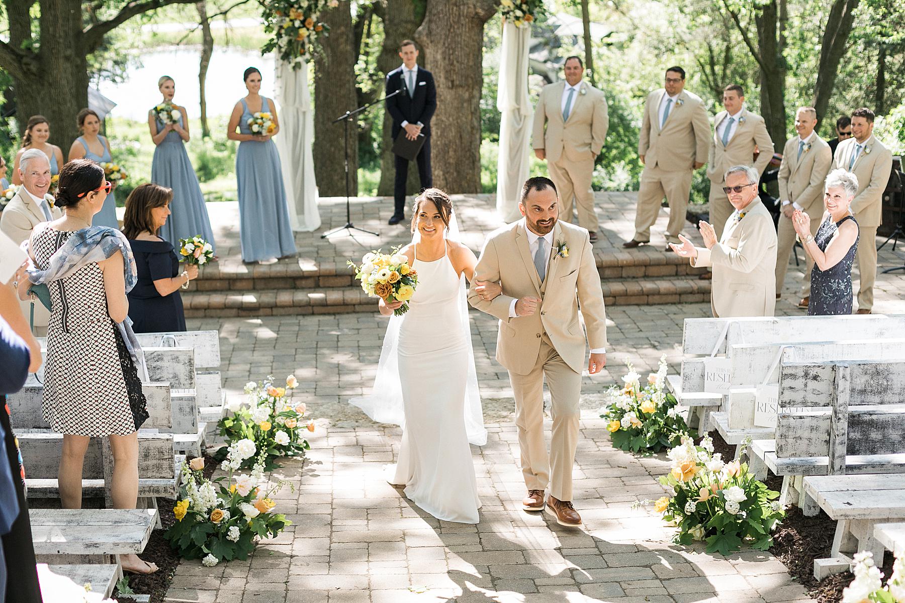 refined elegant outdoor wedding ceremony, with orange and yellow flowers and blue dresses, near madison, wisconsin