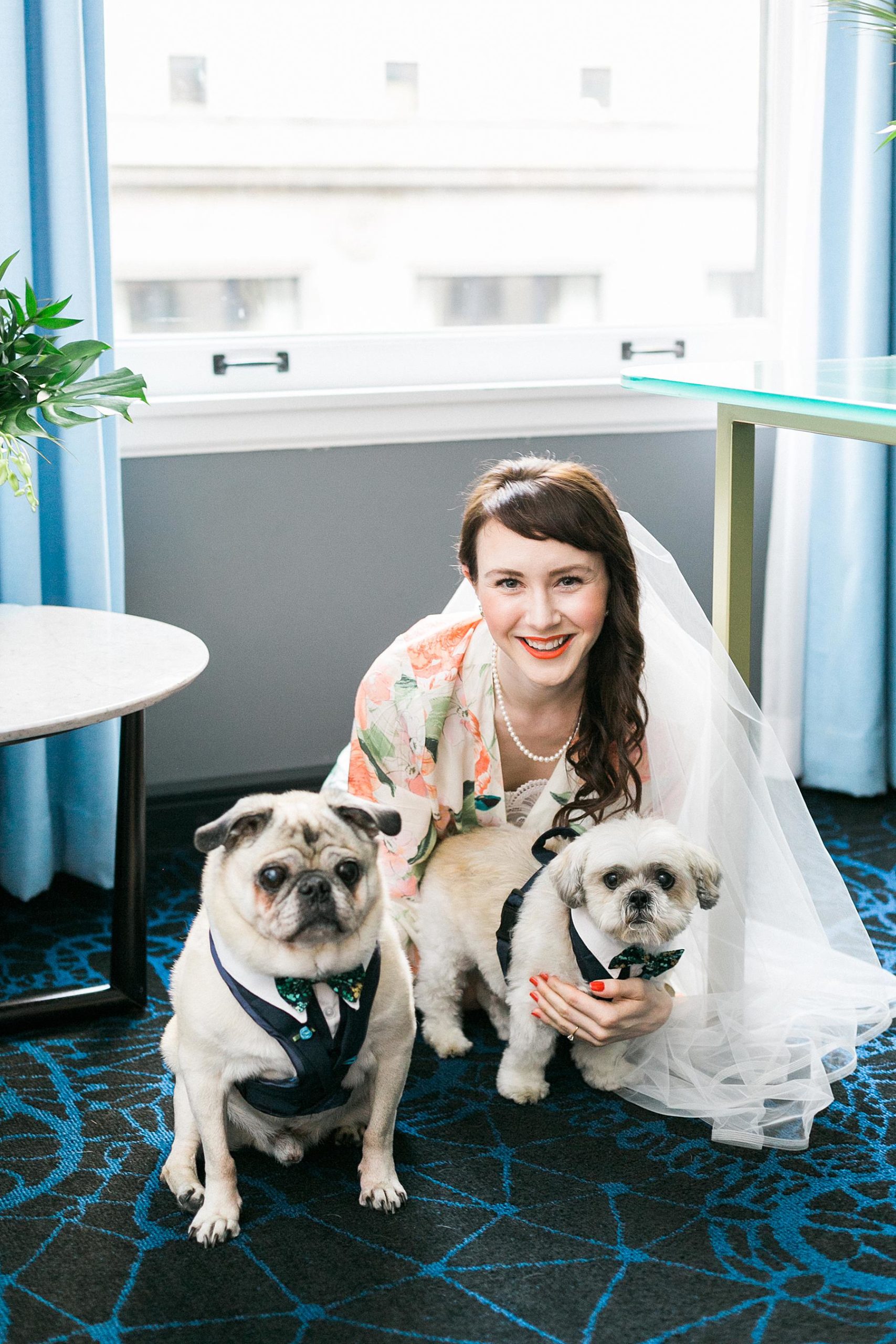 bride getting ready for a kimpton gray chicago boleo wedding with dogs