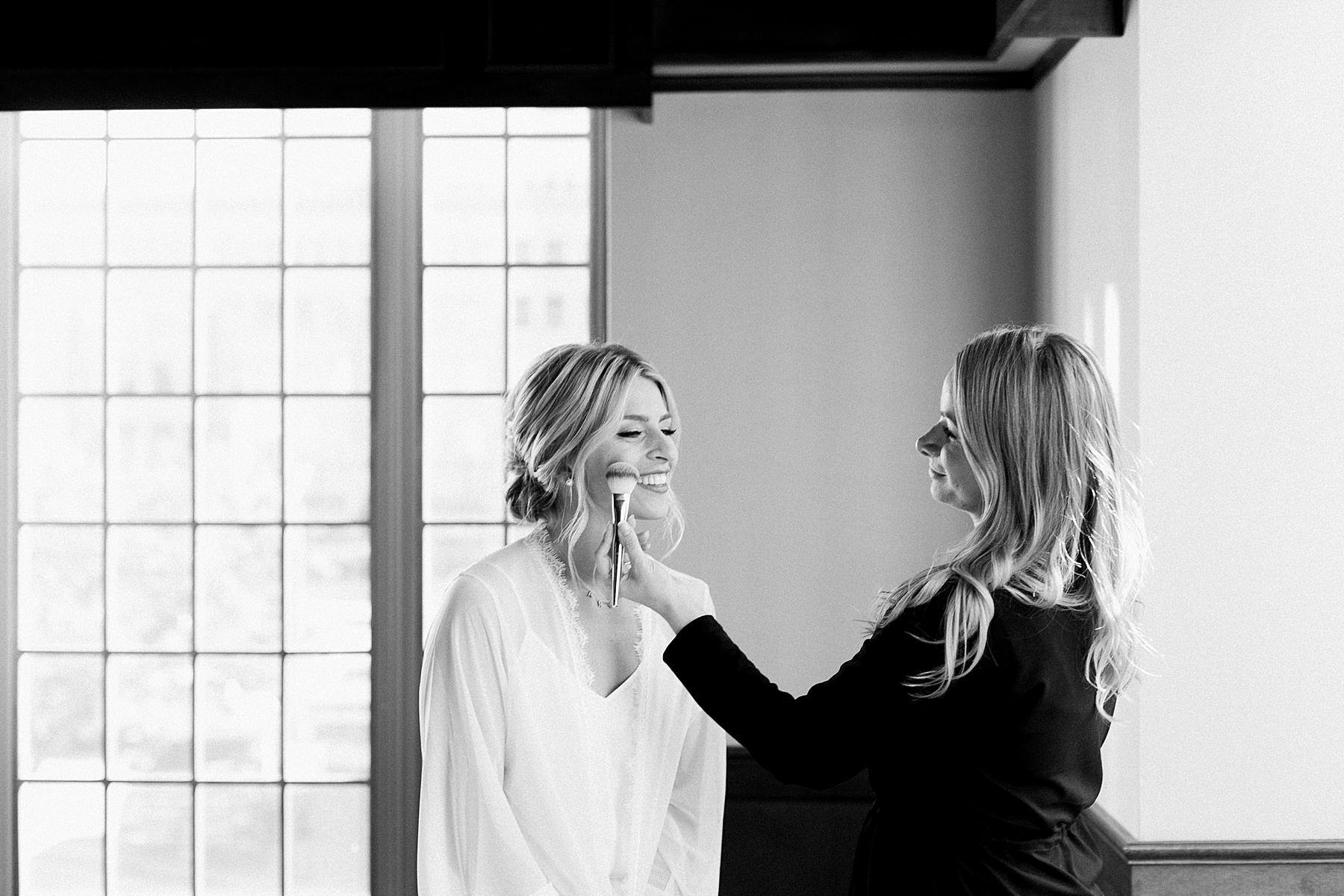 bride getting makeup done getting ready photo