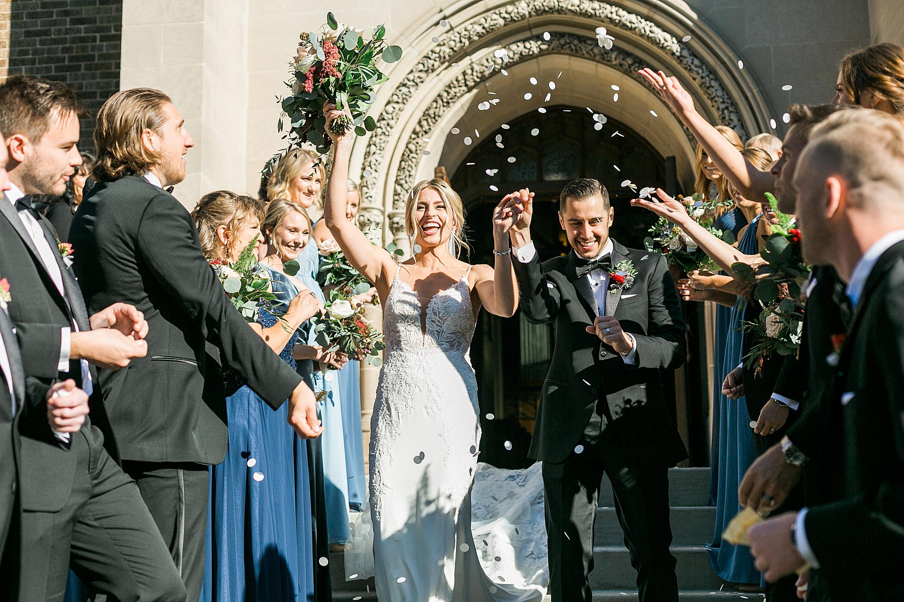 couple exit from wedding ceremony at a church in milwaukee, wisconsin