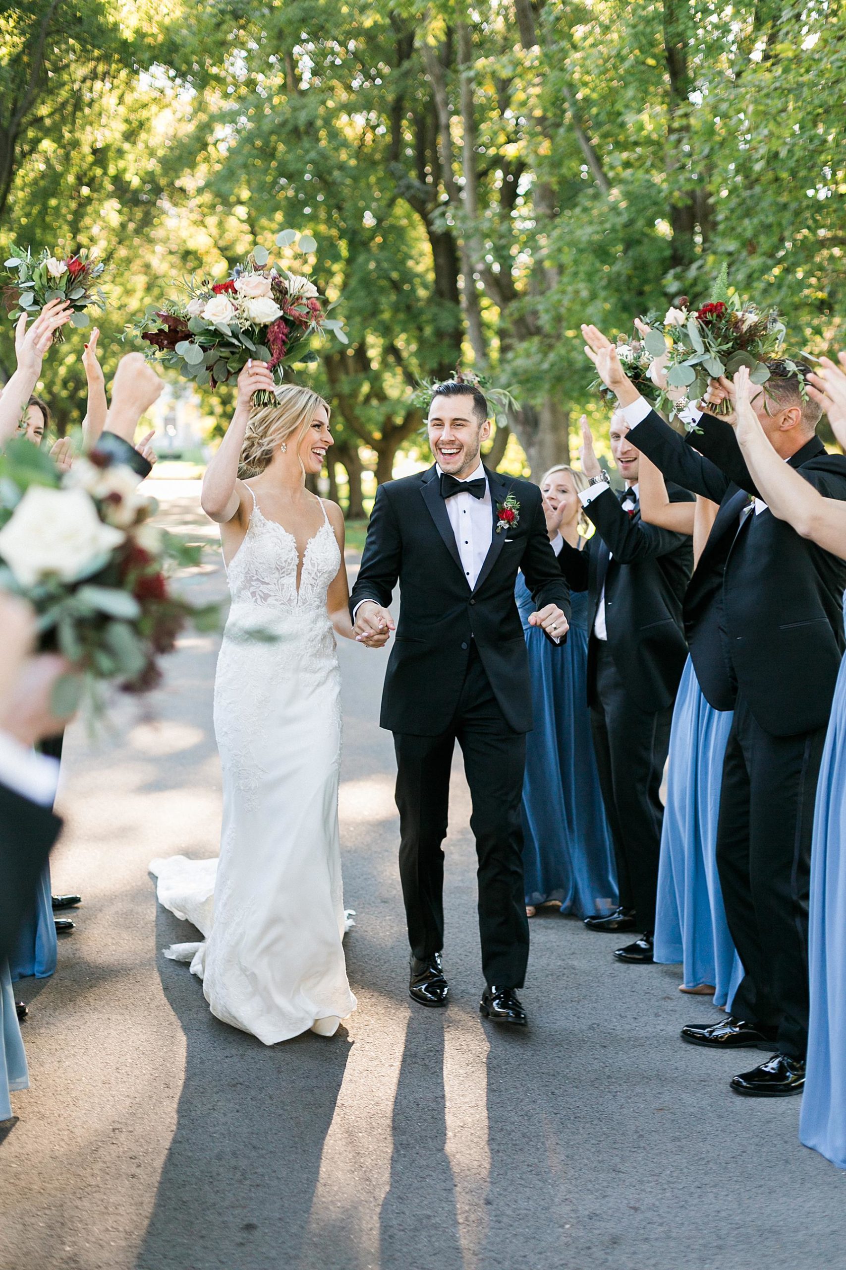 bridal party portraits with blue velvet and chiffon dresses and black tuxes in milwaukee, wisconsin