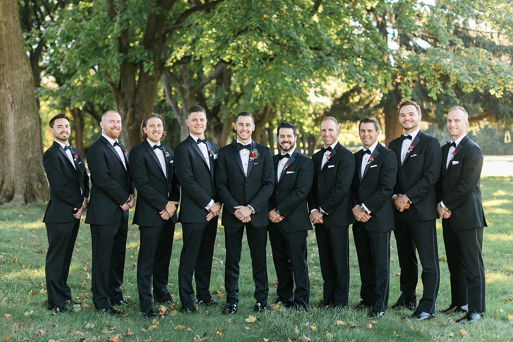 bridal party portraits with blue velvet and chiffon dresses and black tuxes in milwaukee, wisconsin