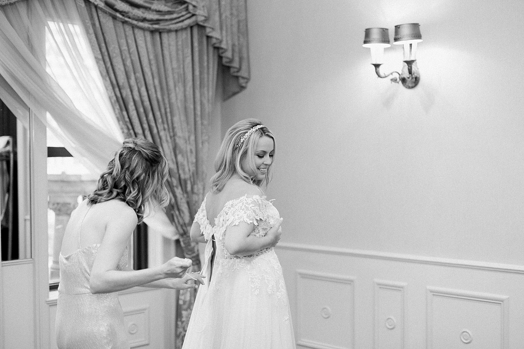 bride getting into her wedding gown dress