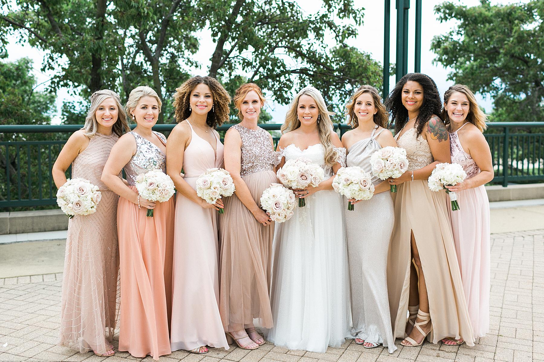 bride and bridesmaids in mauve blush pink and champagne long dresses