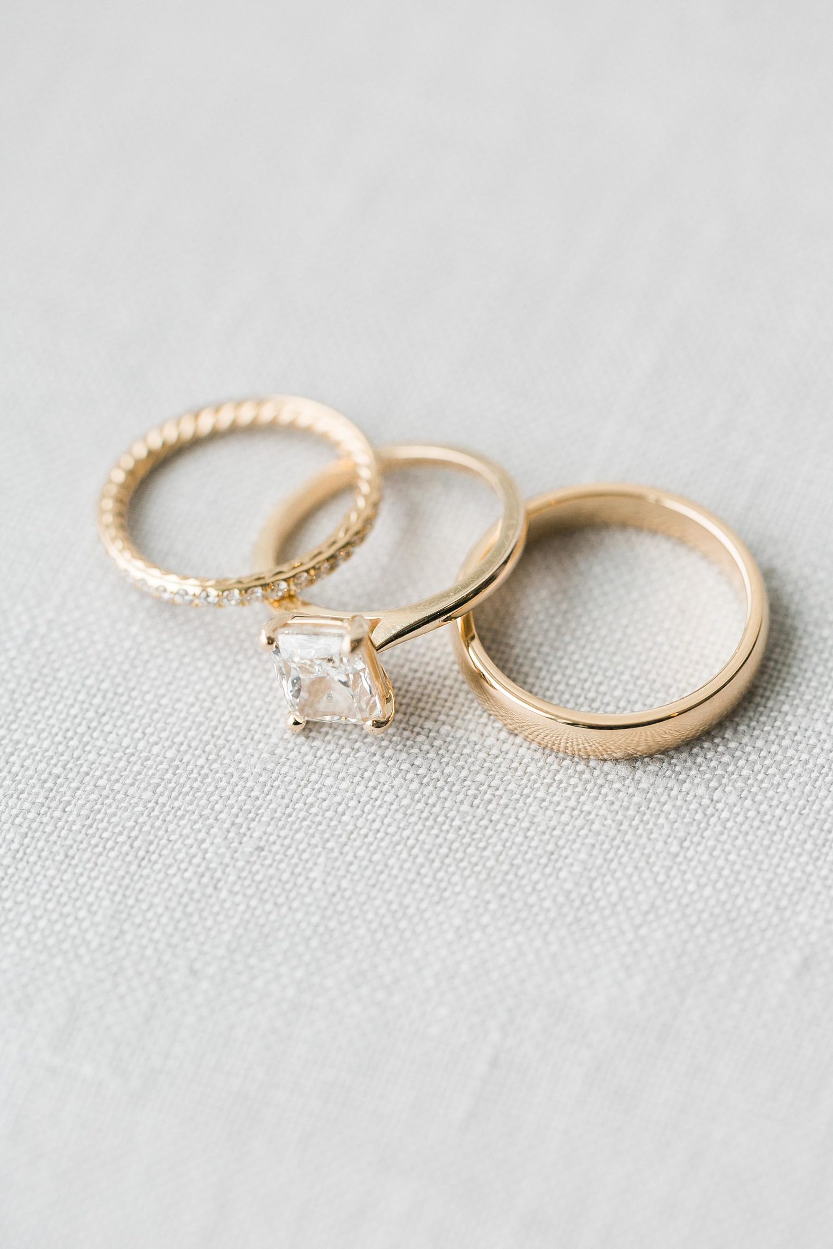 yellow gold wedding rings bands on linen background